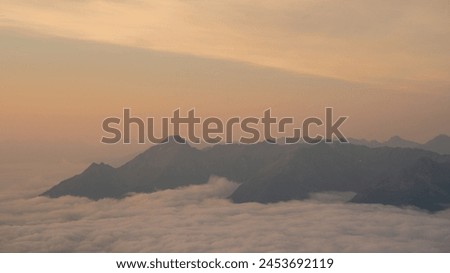 Golden summer sunrise over a cloud inversion in the Hohe Tauern National Park, Osttirol, Austria Royalty-Free Stock Photo #2453692119