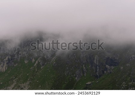 Waterfalls falling from clouds during a summer storm in Hohe Tauern National Park, Osttirol, Austria Royalty-Free Stock Photo #2453692129