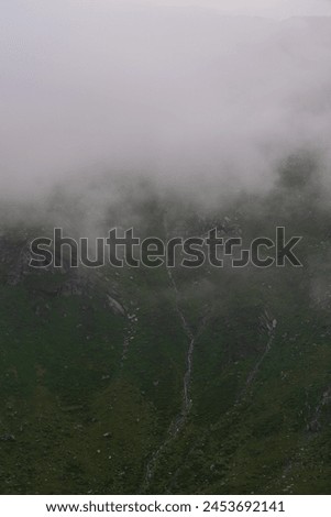 Waterfalls falling from clouds during a summer storm in Hohe Tauern National Park, Osttirol, Austria Royalty-Free Stock Photo #2453692141