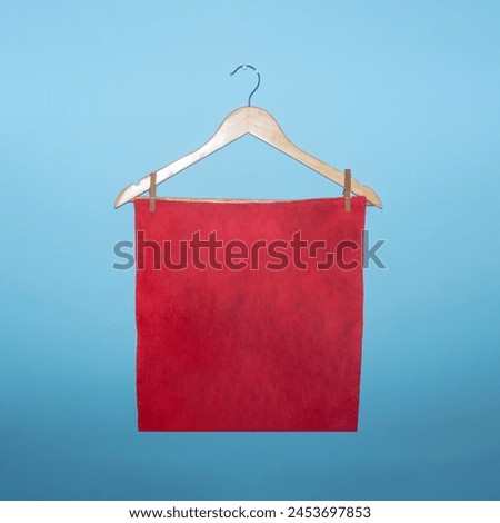 Red cloth on a hanger creative concept with copy space on a blue background.