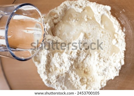 Water flowing into self made dough