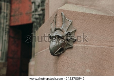 Medieval Gargoyle Sculpture on Sandstone Wall Royalty-Free Stock Photo #2453700943