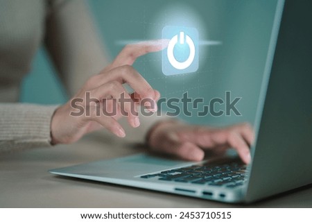businesswoman pressing power button. Start or shut down concept.. Hand of businessman pressing power button over computer. Royalty-Free Stock Photo #2453710515