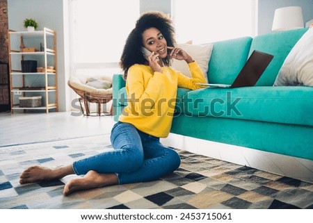 Photo of lovely joyful girl working from comfortable home sitting on floor modern room flat indoors