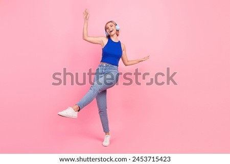 Full body photo of pretty young woman dance empty space wear blue top isolated on pink color background