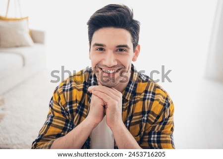 Photo of handsome cheerful guy dressed plaid shirt smiling arms chin enjoying weekend indoors room home house Royalty-Free Stock Photo #2453716205