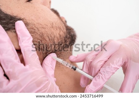 Doctor performing jawline contouring with Botulinum toxin: cosmetic procedure for male patient's facial definition and skincare, Enhancing jaw using botulinum toxin