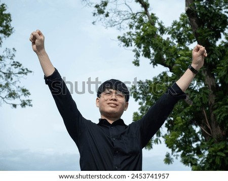 Businessman male man boy gentleman person people cheerful pointing finger happy hand arm body part raise enjoyment celebration summer building success carefree expression strategy business vitality Royalty-Free Stock Photo #2453741957