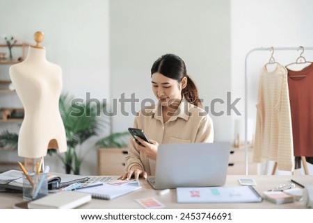 Fashion designer women taking photo color swatch sample for creative new collection on smartphone.
