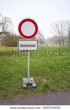  Sign with the German inscription Hochwasser during a flood in Magdeburg in Germany in January 2024. Translation: High water                              