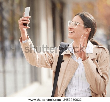 Business woman, selfie and peace sign in city with smile for profile picture, photography and post on web. Person, happy and live streaming with icon, symbol and app on metro street with social media