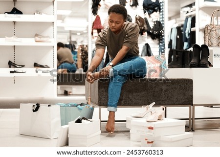 Pain, feet and shoe shopping for black woman, retail and boutique or designer products. Customer, sale and try for wardrobe and sore heels, mall and fashion for new closet purchase and footwear store Royalty-Free Stock Photo #2453760313