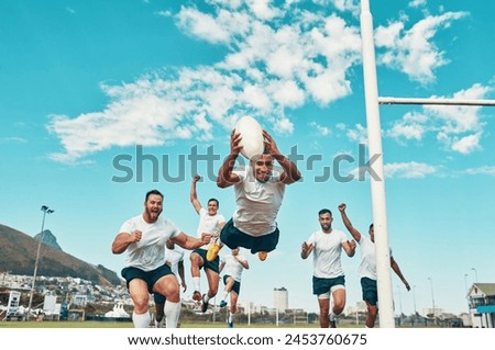 Hes the man of the match. Shot of a rugby player scoring a try while playing on a field. Royalty-Free Stock Photo #2453760675