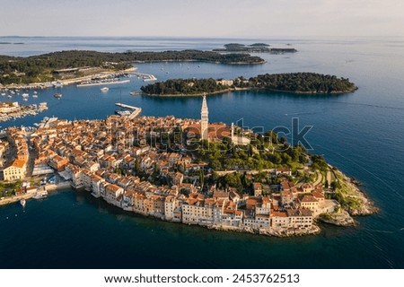 Rovinj, Croatia: Dramatic aerial view of the famous Rovinj medieval old town with its Venetian campanile in Istria by the Adriatic sea in Croatia Royalty-Free Stock Photo #2453762513
