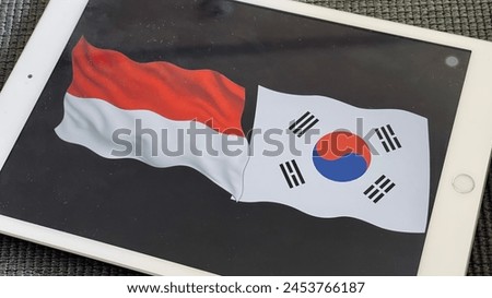 Top view photos on phone of South Korea and Indonesia flag together on black background. Concept of the Asian cup footbal Age 23