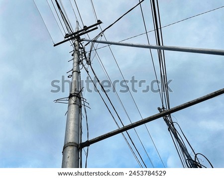 power pole or tiang listrik. Towering through the clouds Royalty-Free Stock Photo #2453784529