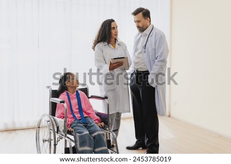 Nurse assisting wheelchair user in hospital