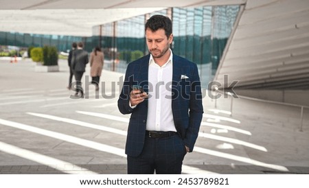 Handsome 30s top manager portrait in formal suit. Successful entrepreneur look camera. Confident business man smile. Young male businessman face. Urban city background. 40s employee work. Office boss.