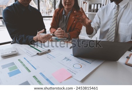 Business group joins together Young Asian businessmen to present and explain investment project reports and planning strategies. Budget calculation Business growth report on a company laptop.