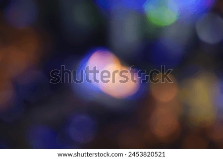 Defocused neon glow. Overlay of light highlights. Futuristic abstract LED backlight. Neon colors blur on dark abstract background