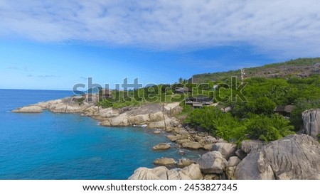 Felicite Island, close to La Digue, Seychelles. Aerial view of tropical coastline on a sunny day. Royalty-Free Stock Photo #2453827345