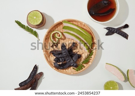 In the center of picture, a rattan tray with a few ingredients for product extract from black locust displayed, black locust can help prevent hair loss. Blank space for displaying or presentation