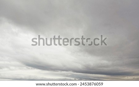 Hurricane Idalia warning sign against a powerful stormy background with copy space. Dirty and angled sign with cyclonic winds add to the drama.hurricane season sign on cloudy background Royalty-Free Stock Photo #2453876059