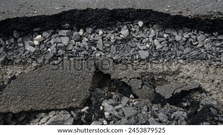 Asphalt road cross section in repair and reconstruction work. To show layer of surface and underground material. asphalt concrete, bitumen, soil, sand, rock, stone, crust, ground and earth. earthquake Royalty-Free Stock Photo #2453879525
