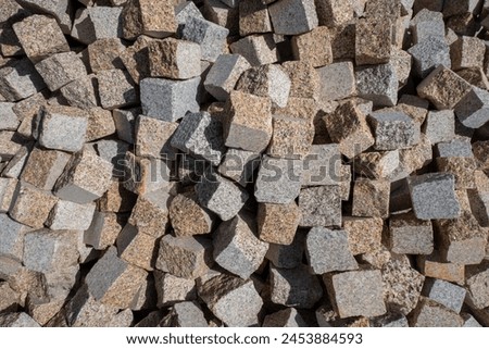 Lot of mini cobblestones: Storage of granite parallelepipeds for paving roads and sidewalks