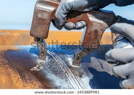 Magnetic particle inspection or magnetic particle testing. It is a nondestructive examination (NDE) technique used to detect surface and slightly subsurface flaws in most ferromagnetic materials. Royalty-Free Stock Photo #2453889981