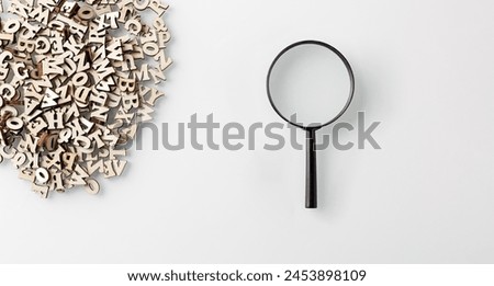 wooden letters english alphabet with lens on white background close up