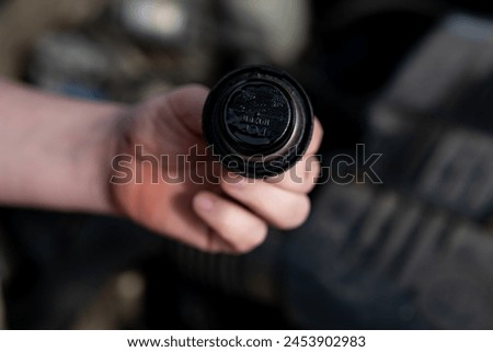 Oil filler cap in a passenger car Royalty-Free Stock Photo #2453902983