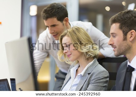 Group of business people in a meeting at office, working on computer