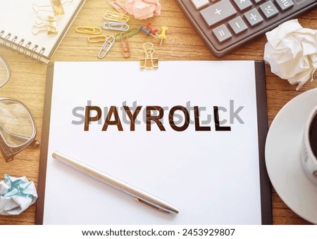 A piece of paper with the word payroll written on it in bold letters.
