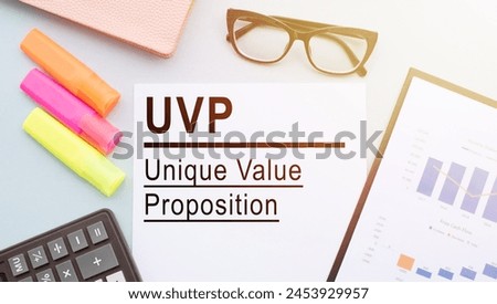 A paper displaying the words Unique Value Proposition placed next to a calculator, symbolizing strategic business planning and analysis.