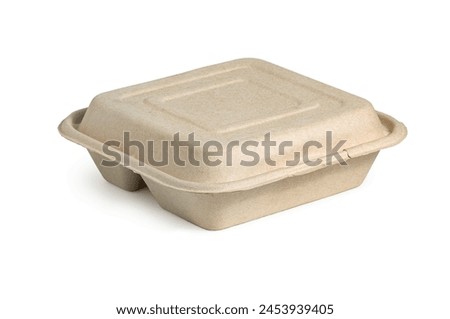 Food containers made of molded pulp or similar biodegradable material. It has a tan or light brown color and a rectangular shape with raised edges to hold food items, isolated on a white background. Royalty-Free Stock Photo #2453939405