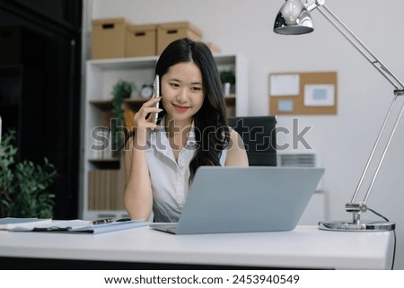Businesswoman talk mobile phones and working on laptop computers, online business.
