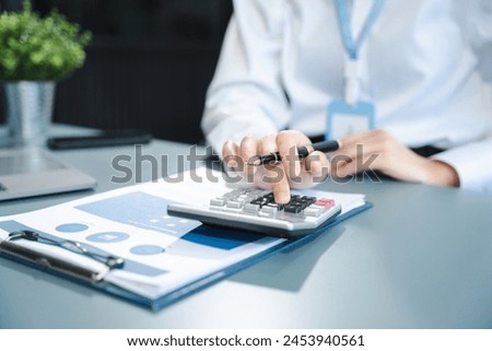 Business woman or financial data analysts working with smartphone and laptop computers and data graphs together. Plan to analyzing projects in the office.