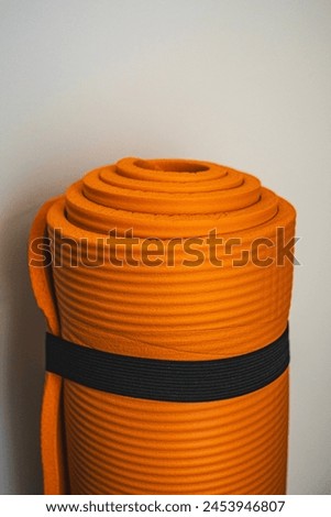Twisted orange yoga mat in the style of film photography