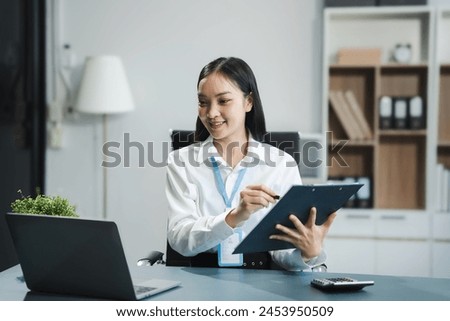 businesswoman working at office with laptop and documents on his desk, financial adviser analyzing data.
