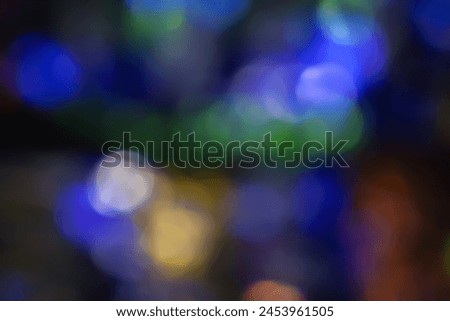 Defocused neon light. Overlaying highlights. Futuristic abstract LED backlight. Blur of neon colors on dark abstract background