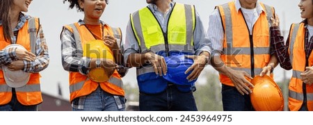 Engineer team holding hardhat standing in row ready for work.Worker diversity group wearing vest,ppe for safety in site train garage.Expert construction project manager leadership.banner cover design. Royalty-Free Stock Photo #2453964975