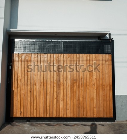 A brown wooden house gate, with white house walls, building, stock photo.