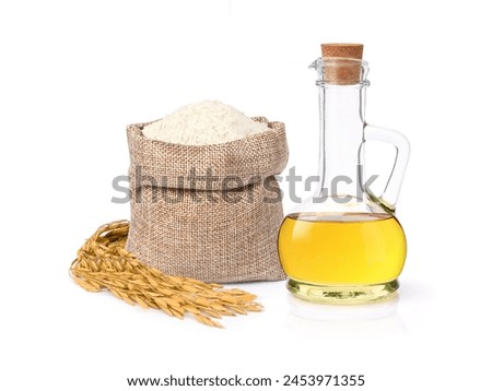 Rice bran oil extract with paddy and white rice on white background. Royalty-Free Stock Photo #2453971355