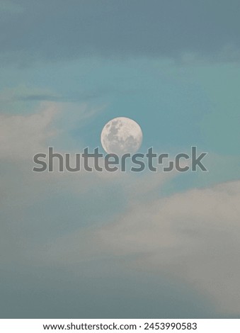 beautiful full moon in cloudy sky in the afternoon 