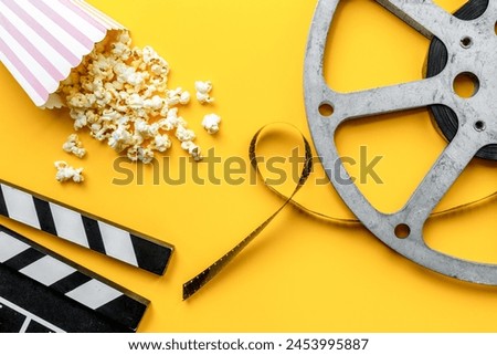 Vintage film reels and popcorn - cinema concept, top view.
