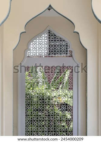 Interior diminishing perspective view with gable partitions wall inside Bang O mosque leading into Carved wooden wall. Mosque architecture and art concept, Space for text, Selective focus. Royalty-Free Stock Photo #2454000209