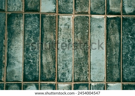 A pattern of modern vertical rectangular malachite tiles. Realistic texture. The walls are lined with green ceramic tiles with space for copying. High quality photo