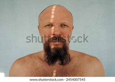 Men's beard. The guy's face is large. Brutal macho. Mustache and beard. Barber. Lumberjack. Portrait of a handsome man with a beard                                Royalty-Free Stock Photo #2454007545