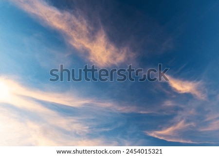 Colorful clouds are in deep blue evening sky, natural background photo